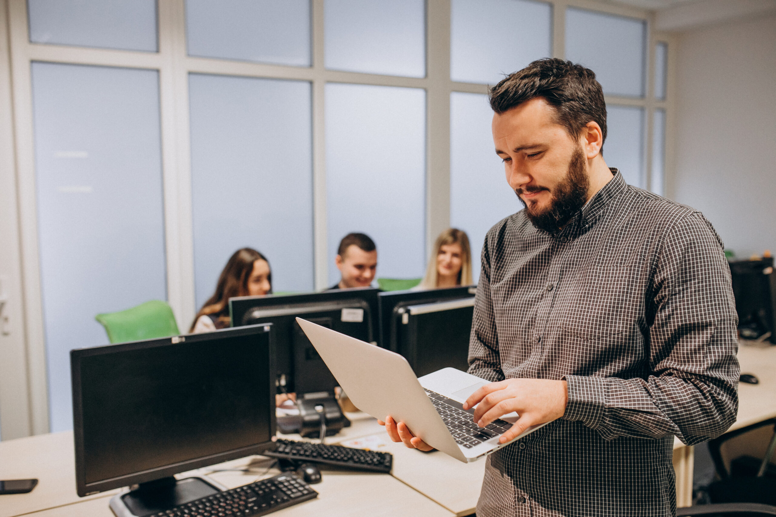 Workers at an IT company working on a computer